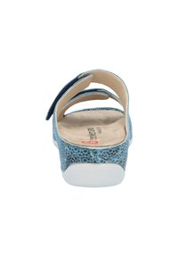 Blue faux leather sandal with a textured surface, open back, dual straps, and a light-colored insole. White sole.