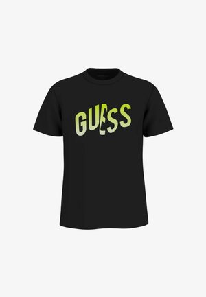 T-shirt nera a maniche corte con logo GUESS distorto di colore verde lime stampato sul petto.