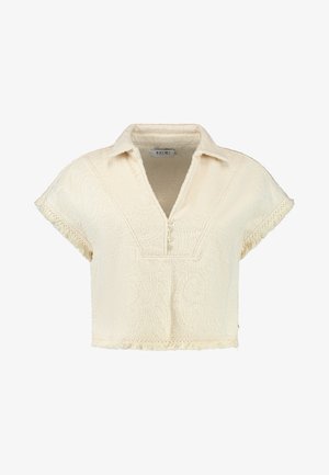 Cream-colored cropped shirt with a collared neck, short sleeves, textured fabric, decorative patterns, and fringe detailing at the hem.