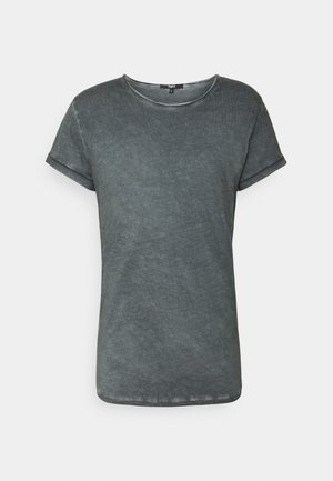 Grå, kortærmet T-shirt lavet af blødt stof. Har en rund udskæring og rullede manchetter med en let struktureret overflade.
