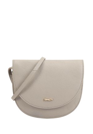 Small beige leather crossbody bag with rounded flap and thin strap, featuring a small gold animal logo on the front.