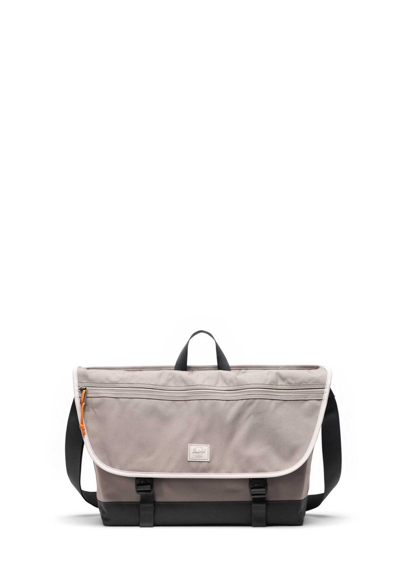 Grijze stoffen schoudertas met een handvat aan de bovenkant, zwarte basis, verstelbare schouderriem, voorklep met sluiting en een oranje ritsdetail.