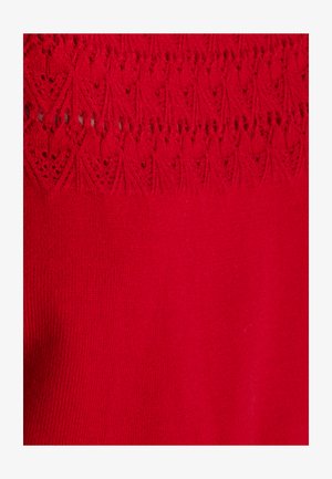 Tessuto di maglia rosso con un motivo in pizzo testurizzato nella parte superiore, accompagnato da una morbida costina orizzontale nella sezione inferiore.