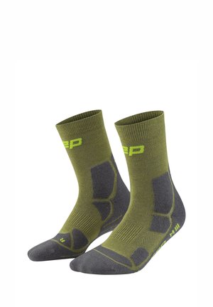 Pair of green and dark gray mid-calf socks with cushioned areas and yellow branding details.