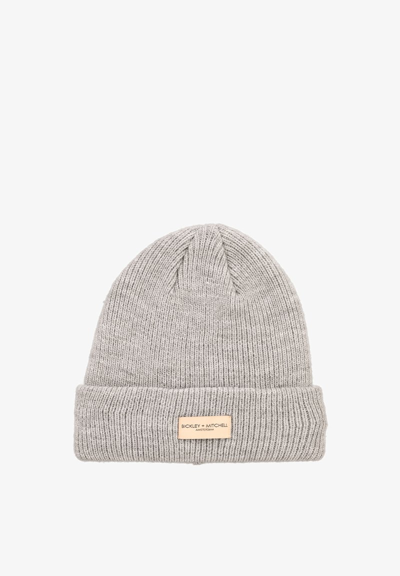 Gray knitted beanie with a ribbed texture and a folded cuff. Features a rectangular leather logo patch on the front.