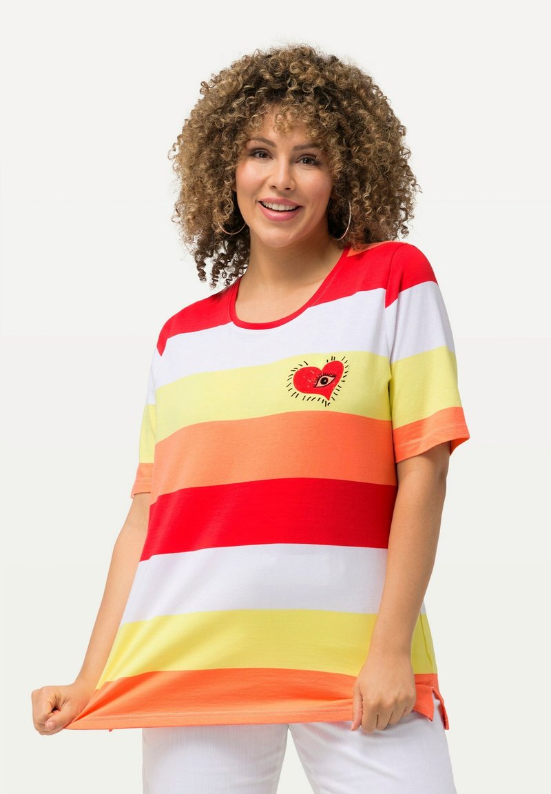 Pruhované tričko v červené, oranžové, žluté a bílé barvě s kulatým výstřihem. Na levé části hrudi se nachází design srdce. Vyrobeno z měkké tkaniny.