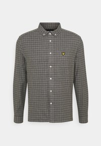 Mans långärmad skjorta i mörkgrått med ett vitt rutig mönster, knäppning vid kragen och en liten gul logotyp på bröstet. Tillverkad av bomull.