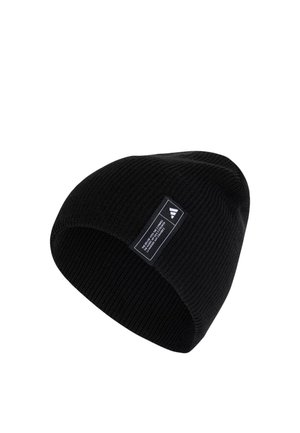 Black knit beanie hat with a folded cuff, featuring a rectangular white label with black text and geometric design accents. Smooth texture.