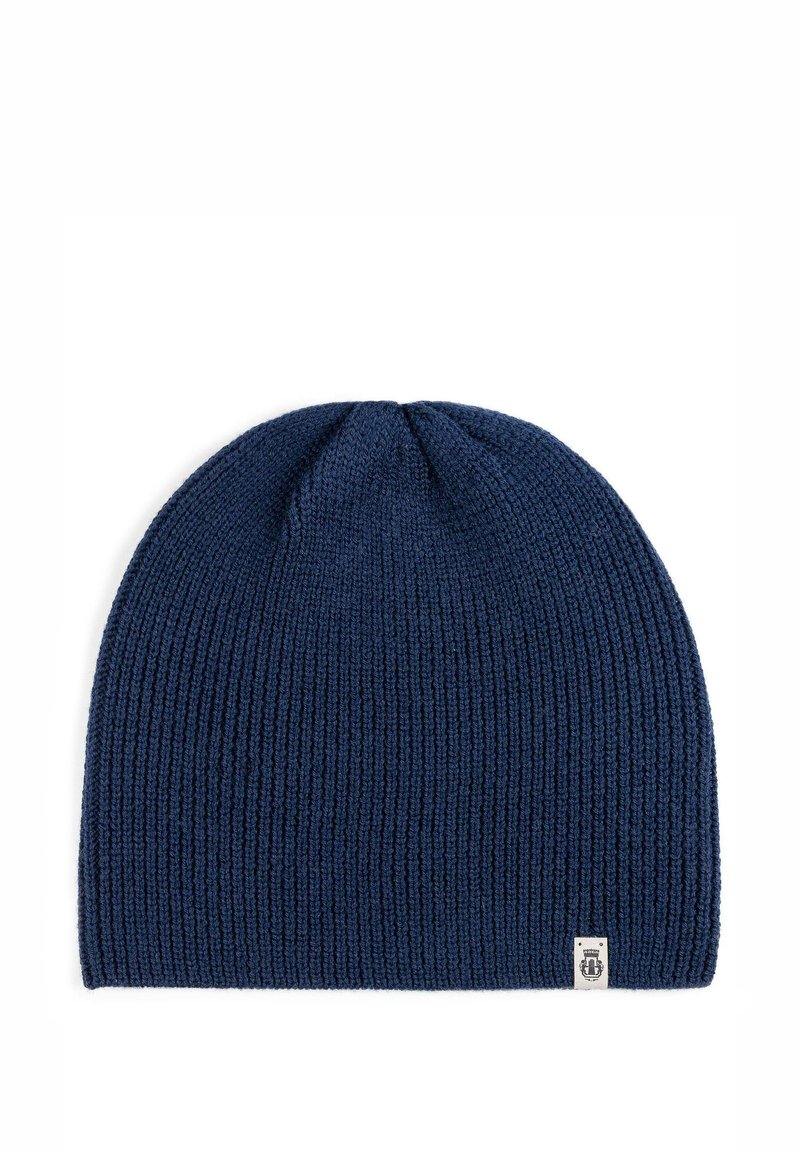Navy blue knitted beanie hat with a ribbed texture, featuring a small white logo label on the side. Soft, stretchable fabric, rounded shape.