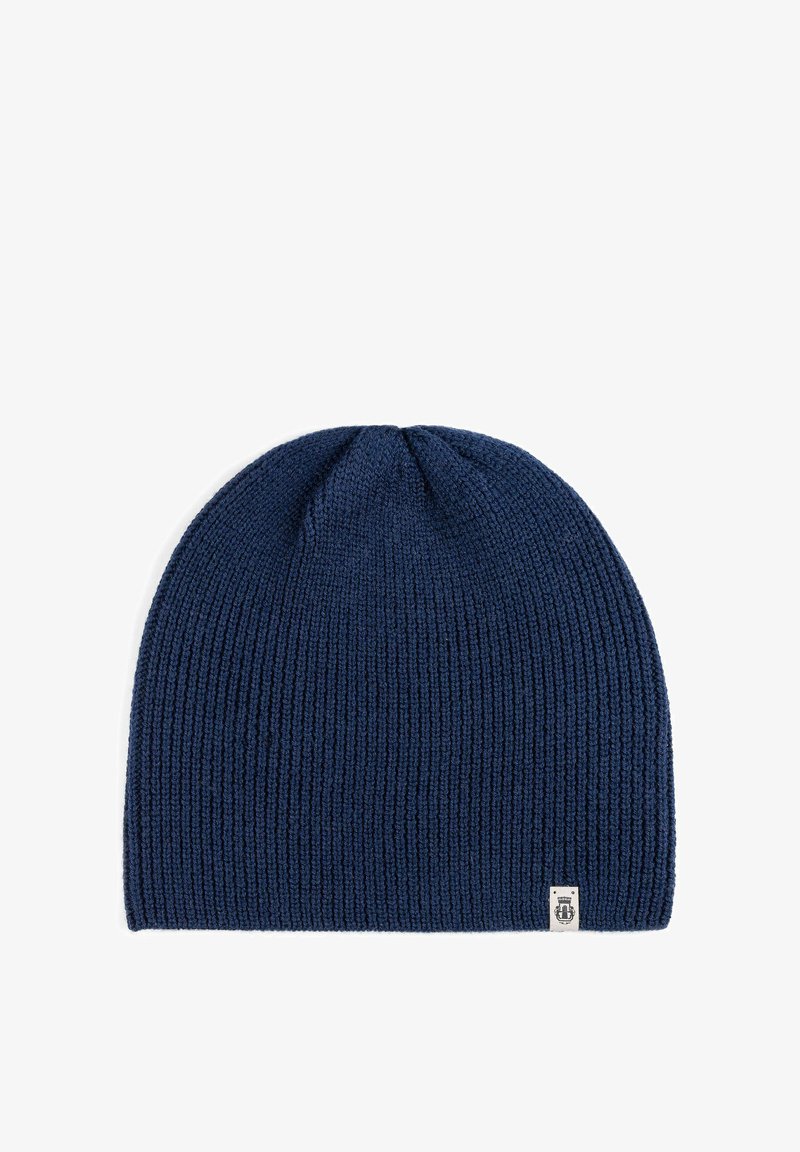 Navy blue knitted beanie hat with a ribbed texture, featuring a small white logo label on the side. Soft, stretchable fabric, rounded shape.