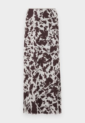 Lang nederdel med et cow print mønster i brun og hvid. Fremstillet af letvægtsstof med en lige silhuet og kant.