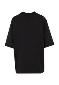T-shirt nera a maniche corte con scollatura rotonda, realizzata in cotone. Il design è minimalista con una vestibilità rilassata e senza motivi o accenti visibili.