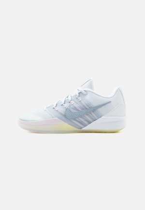Hvid lav sneaker med mesh-overdel, snørebånd foran, gennemsigtig sål og gråt Nike Swoosh-logo på siden.