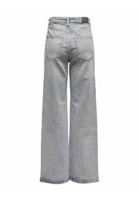 Jeans anchos grises con una cintura alta, que presentan dos bolsillos traseros, líneas limpias y una textura de denim suave. La cinturilla tiene una etiqueta negra.