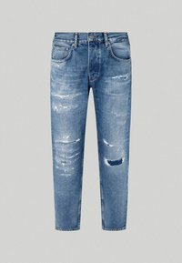 Jeans de mezclilla azul claro con un corte ajustado, que presentan áreas desgastadas y parches rasgados. Diseño clásico de cinco bolsillos y cierre de botón.