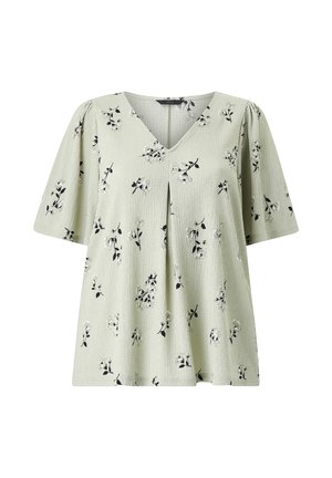 Lysegrøn kortærmet bluse med sort og hvidt blomstermønster, V-hals og frontplissé-detalje.