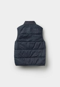 Námorně modrá prošívaná bezrukává vesta s vysokým límcem, zobrazena zezadu na bílém pozadí.