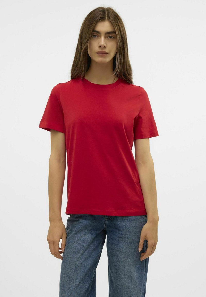 Rode katoen t-shirt met korte mouwen, voorzien van een klassieke ronde hals en een comfortabele pasvorm, gecombineerd met blauwe high-waisted jeans.