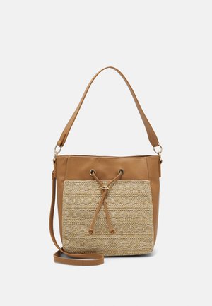 Tan shoulder bag with woven front pocket, drawstring detail, and detachable long strap against a white background.