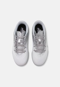 White athletic shoes with a smooth, textured upper featuring a silver gradient pattern, narrow laces, and a padded collar and tongue.