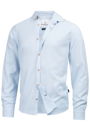 Light blue long-sleeve button-up shirt made of soft fabric. Features a collar, wooden buttons, and a slightly curved hem.