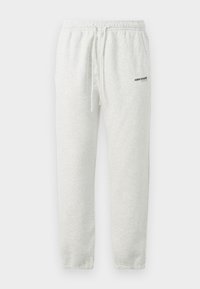 Pantalones de chándal grises de algodón con cinturilla elástica, cordón y corte holgado. Cuenta con un pequeño logo en el muslo izquierdo.