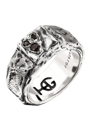 Silver textured ring with three black gemstones set unevenly on top and engraved "JGJ 925" inside band.