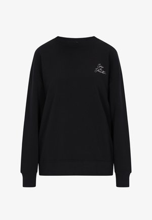 Črna trenirka s krožnim ovratnikom, padajočimi rameni in dolgimi rokavi. Ima šivano belo besedilo na zgornji levi strani. Mehka tekstura.