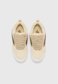 Beige and brown suede sneakers with textured woven laces, round toe design, and white rubber sole. Pull tab at the heel for easy wear.