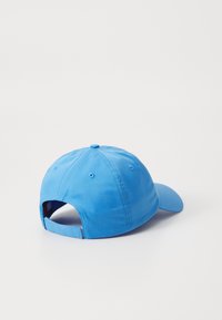 Blue cotton baseball cap with a curved brim, adjustable back strap, and stitched vents. Smooth texture and solid color design.