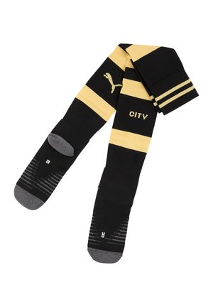 Sort og gulstribede Puma sportssokker med grå tæer og hæle, med teksten "CITY" og venstre/højre fodmærker.