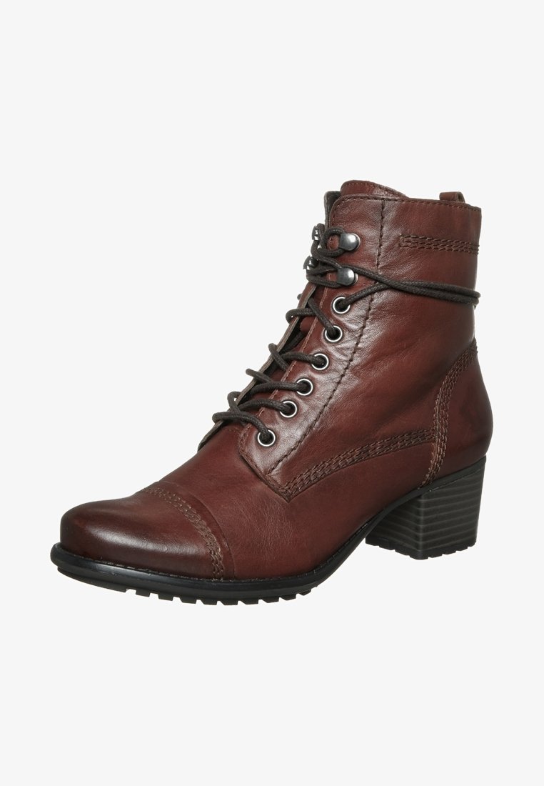 Bottine en cuir marron avec laçage devant, couture décorative, bout rond et talon bloc superposé.