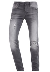 Šedé denimové džíny slim fit, s vybledlými a poškozenými oblastmi. Obsahují přední kapsy a kovové knoflíky.