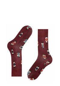 Bordeauxfarbene Socken mit einem Nussknacker-Muster in verschiedenen Farben. Weicher Stoff, Knöchellänge, glatte Textur und verstärkte Ferse und Zehen.