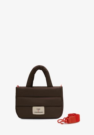 Brown padded handbag with double handles, rectangular shape, a front label, and an unbuckled red detachable shoulder strap beside it.