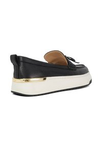 Black leather slip-on shoe with a rounded shape, a gold-accented platform sole, and a smooth interior lining. Features a decorative bow detail.