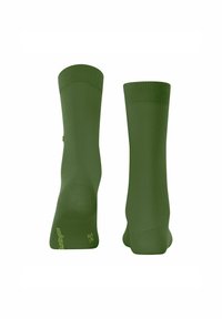 Zielone skarpetki prezentowane z boku, podkreślające dzianą teksturę i prążkowane mankiety, z logo na dole jednej skarpetki.