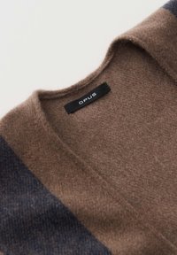 Brown wool cardigan with a V-neck, featuring dark blue accents on the sleeves and a black label with "OPUS" inside the neckline.