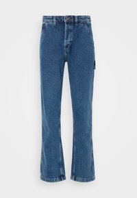 Jeans de tiro alto y acampanados en denim azul medio. Cuenta con un cierre de botón en la parte delantera, dos bolsillos laterales y un bolsillo de parche en la pierna.