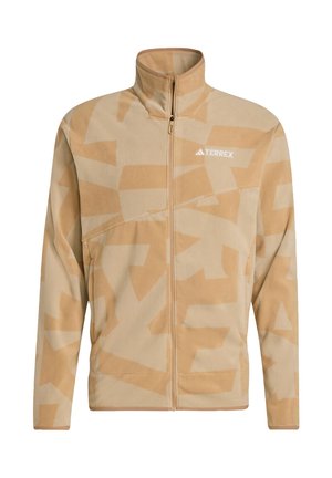 Beige fleecejakke med abstrakte tan-mønstre, høj krave, lynlåslukning og TERREX-logo på brystet. Blød tekstur og afslappet pasform.