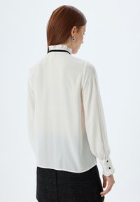 Koton RUFFLE HIGH NECK - Button-down blouse - off white