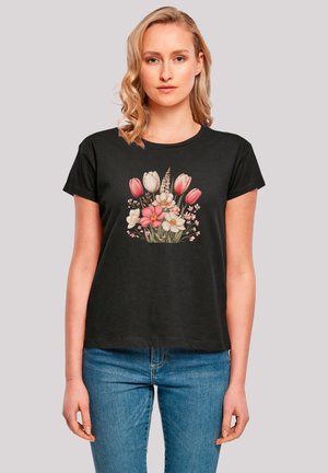 Schwarzes T-Shirt mit kurzen Ärmeln, das ein lebhaftes Blumenmotiv in Pink, Weiß und Grün zeigt, in lässiger Passform und mit weichem Material.