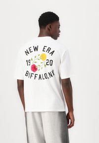 White cotton t-shirt featuring a floral graphic, "NEW ERA," "BUFFALO, NY," and the year "1920" in bold black text on the back.