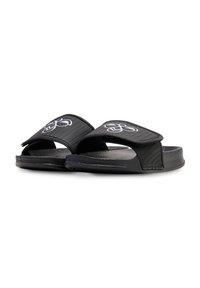 Black slide sandals with a textured upper, dual straps, and a logo on the top. Made of rubber with a flat sole design.