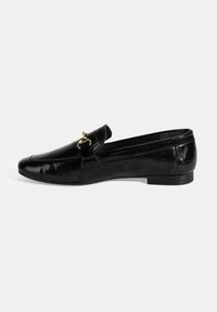 Zwarte gepatenteerde leren loafers met een ronde neus, gouden hardware accent, lage hak en een gestructureerd patroon op het oppervlak.