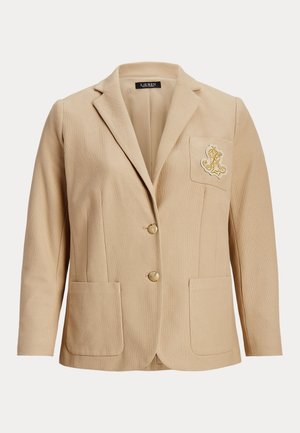 Blazer bege com um tecido texturizado, dois bolsos frontais, dois botões dourados e um bolso no peito com um logótipo bordado.
