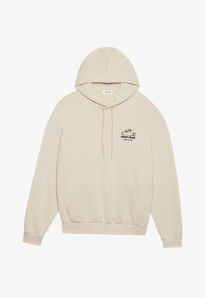 Beige hoodie in soft fabric, featuring a front pocket, adjustable drawstring hood, and a graphic print of stars and text on the chest.