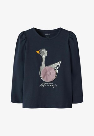 Marineblauw shirt met lange mouwen, voorzien van een zilveren en gele geborduurde zwaan met een paarse stofaccent. De tekst luidt "Life is magic."
