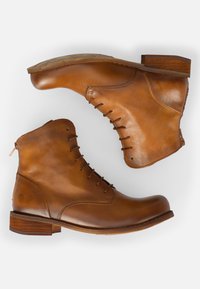 Brown leather ankle boots feature a round toe, lace-up front, and a small wooden heel, with a side zipper and textured finish.