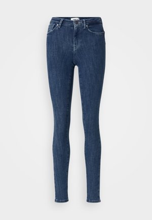 Dunkelblaue, hoch-taillierte Skinny-Jeans mit Knopf- und Reißverschluss, Vordertaschen und Gürtelschlaufen auf einem schlichten hellen Hintergrund.
